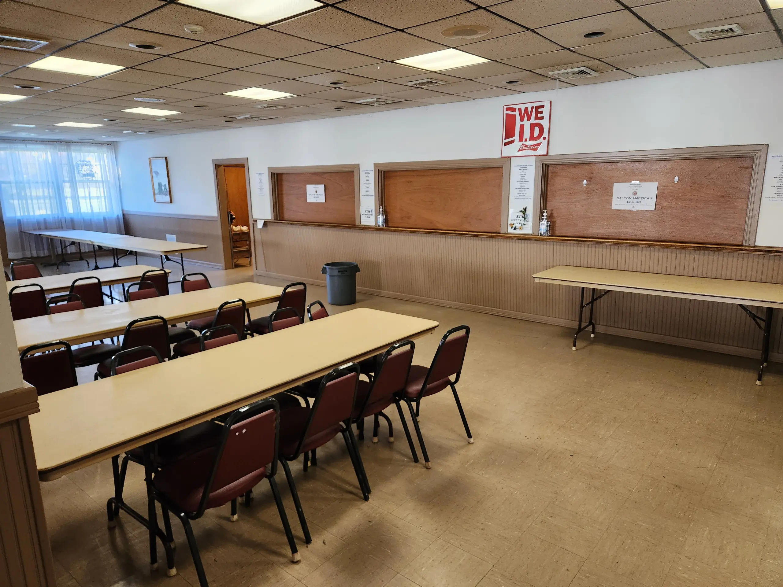 Empty cafeteria with tables and chairs arranged neatly.