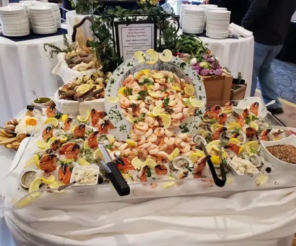 Elegant seafood platter with shrimp, crab legs, and garnishes on ice.