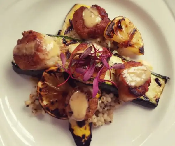 Grilled vegetables topped with melted cheese and herbs.