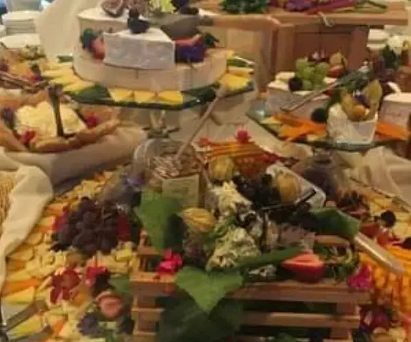 A lavish buffet spread with various cheeses, fruits, and appetizers.