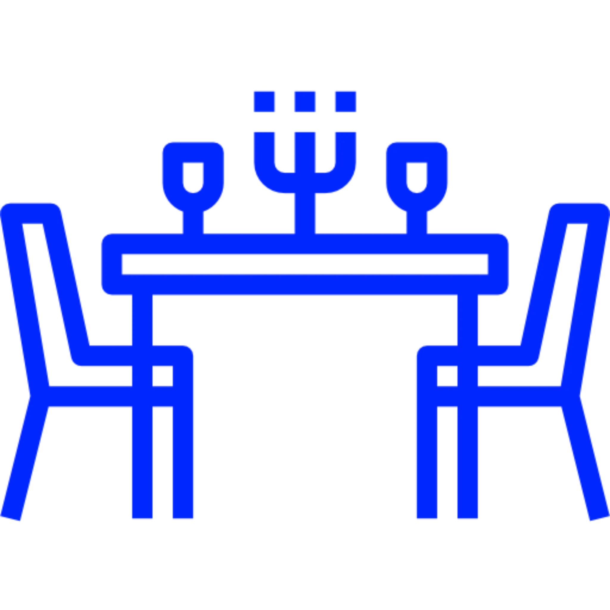 Blue icon of a dining table with a cake and two glasses, surrounded by four chairs.