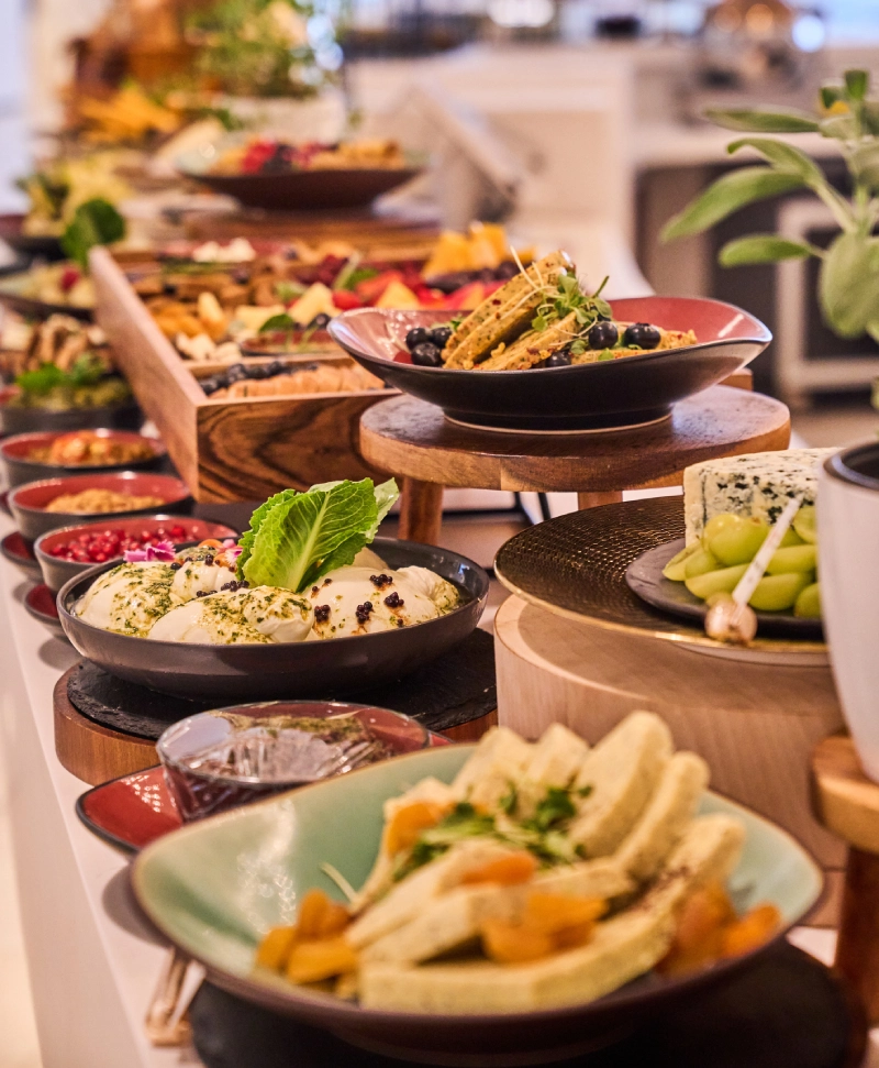 A vibrant buffet with diverse dishes and fresh salads.